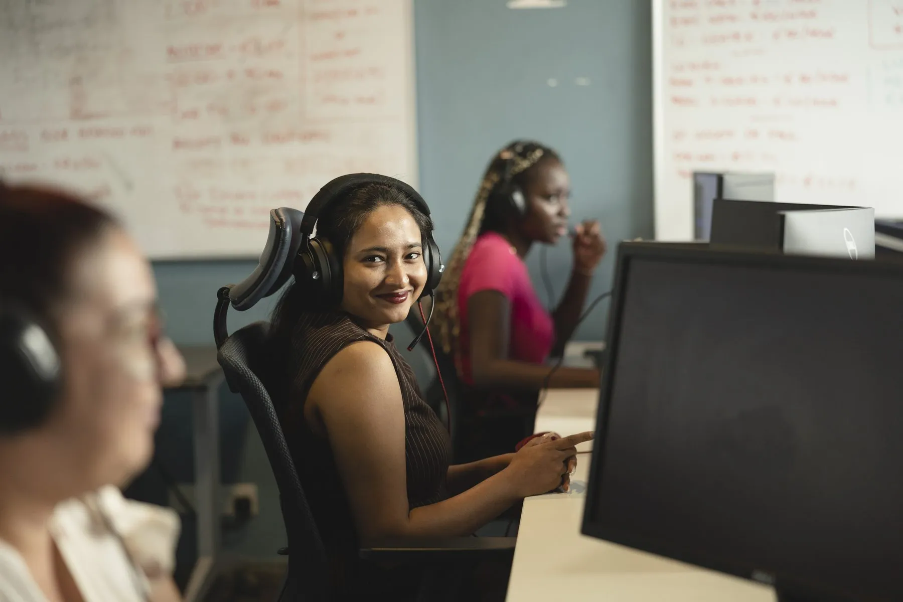 Call-centre agents with headsets at their desks