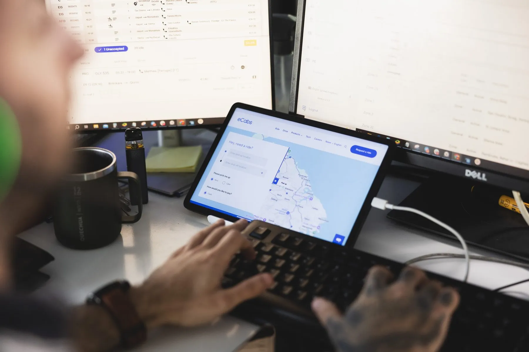 The dispatch portal on a tablet beside a desktop workstation