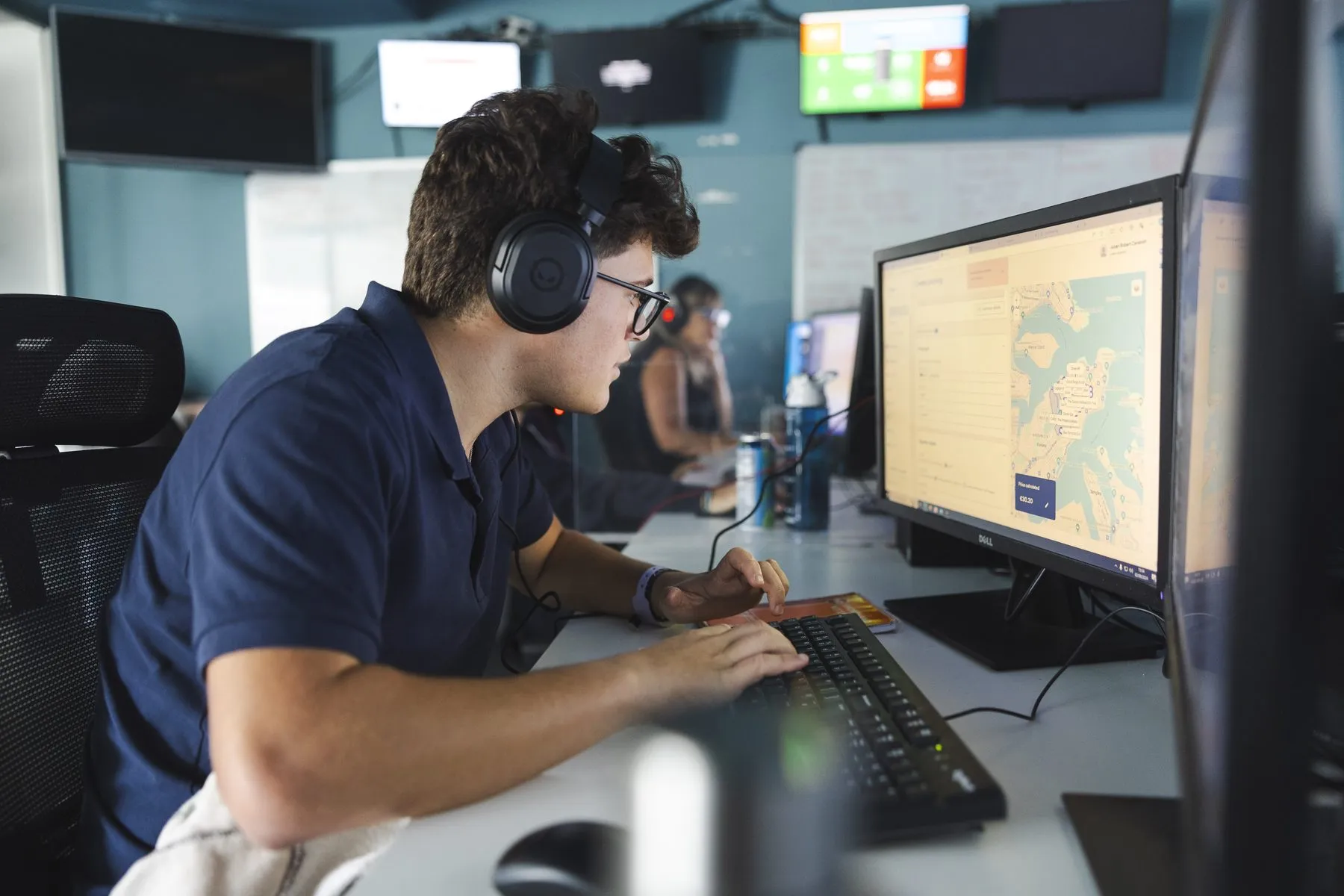 A dispatcher handling bookings with the live map on screen
