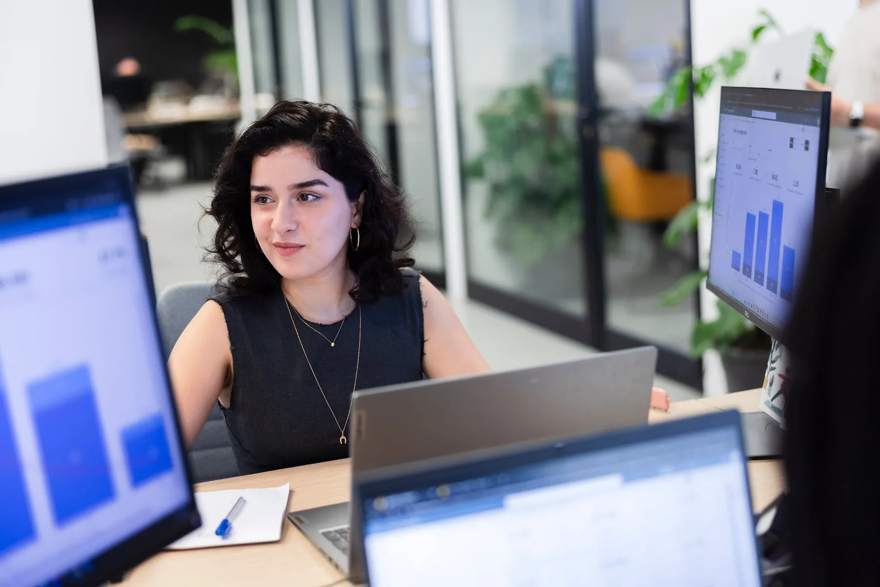 eCabs Technologies team member at work, with analytics dashboards on screen