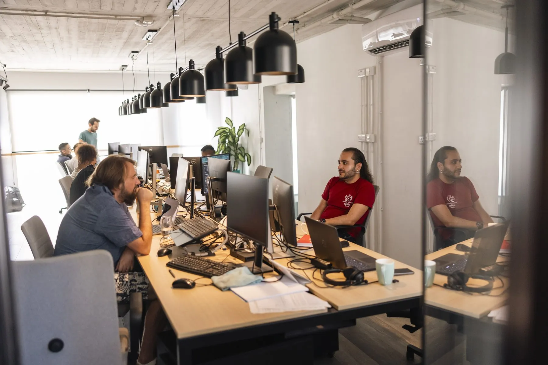 The open-plan office of the technology team