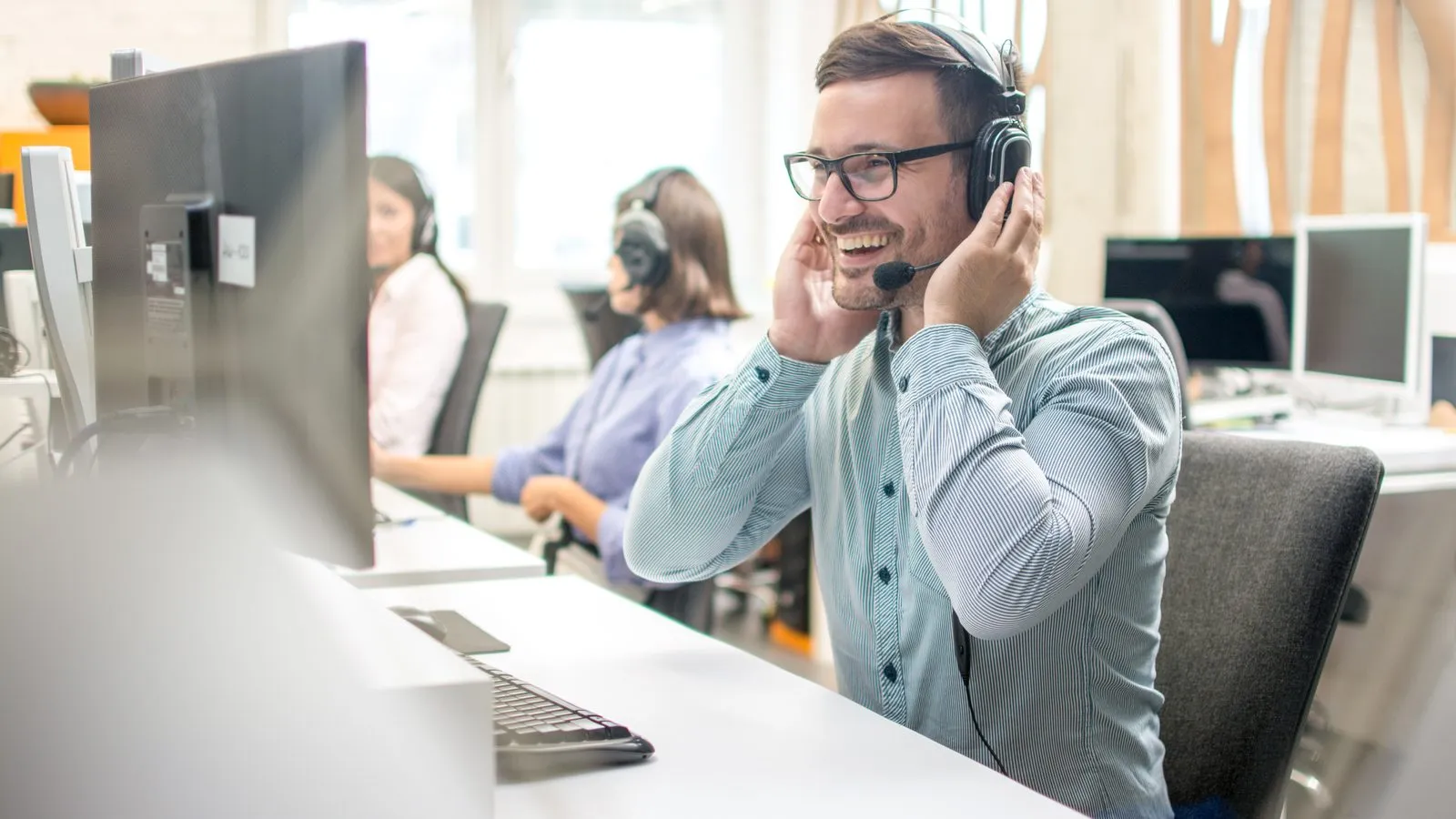 Taxi dispatcher with a headset taking a booking call